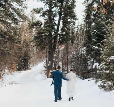 Kristina Werner with her husband, Derek Hansen on the middle of the snowy forest in California at the time of their wedding. What does Werner's husband do for a living?